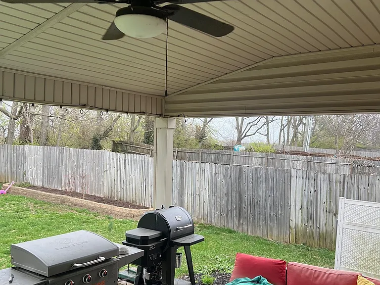Covered back patio, perfect for enjoying the outdoors in all weather conditions.