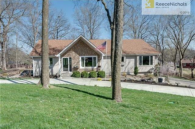 Front elevation with circular drive; extra wide driveway w. additional parking on the right.