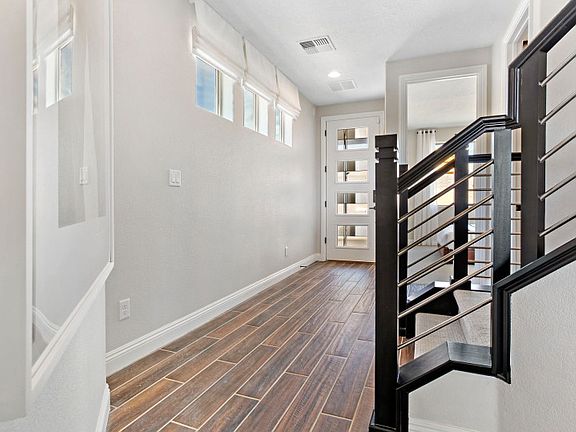 The beautiful foyer of the Park Place leads you to the stairs, a downstairs secondary bedroom, and a