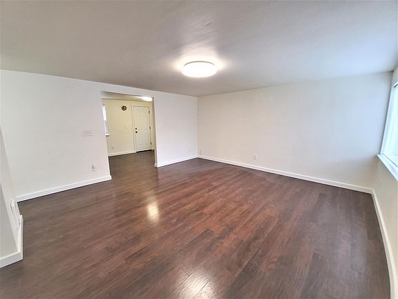 Spacious living room with hard wood flors