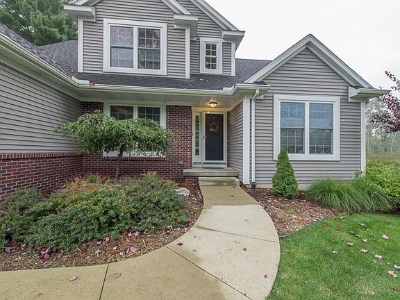 An inviting front entry and professionally landscaped lawn welcome you home.