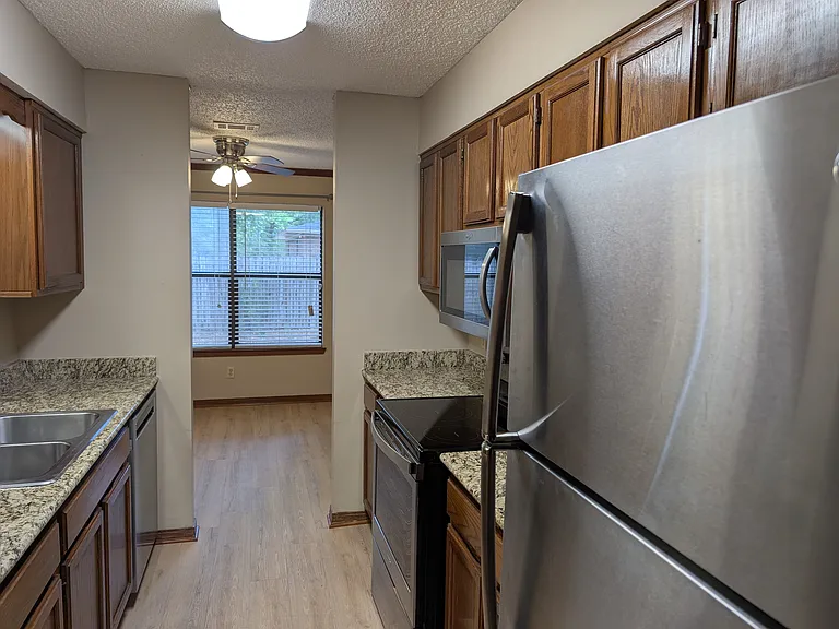 Ceiling Fan in Dining Area. Peaceful backyard view and access to back porch and storage from both the dining room and the master bedroom.
