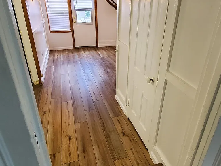 View of Back Entry door as seen from the carpeted Bedroom