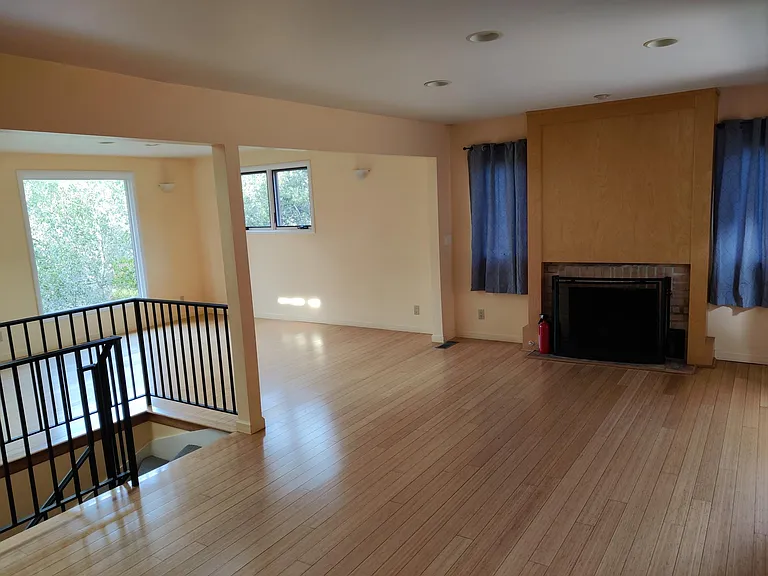 Upper floor living area view from kitchen - natural gas burning fireplace