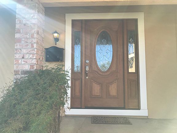 Gorgeous wood entry with side glass panels!