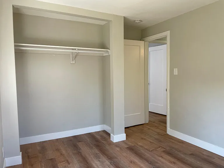 Second bedroom with large reach in closet and windows to backyard