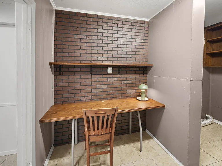 Built in desk area next to the laundry area with shelves