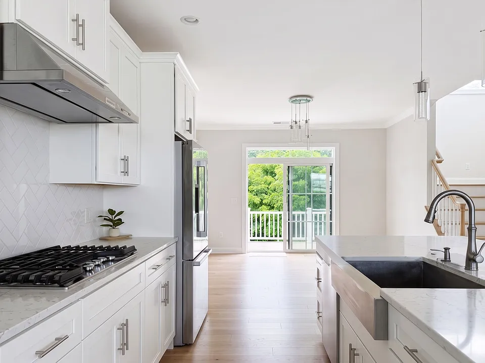 Seamless flow from kitchen into dining area with glass sliders to the private outdoor deck.