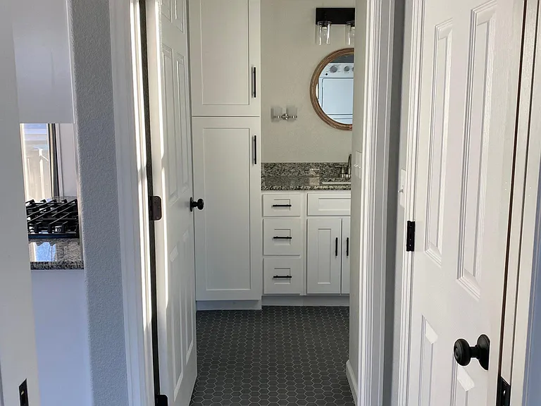 Bathroom cabinets provide ample storage for personal items and linens.