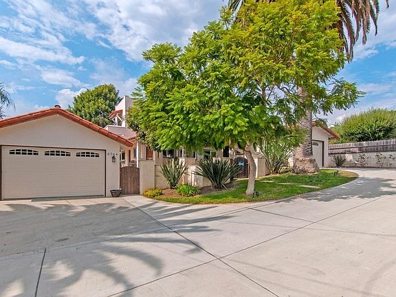 view of the main house with upper and lower garages