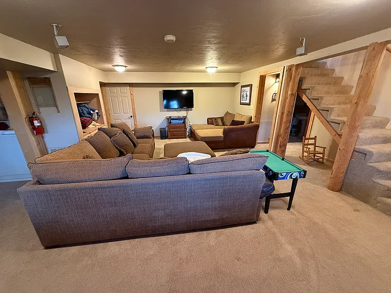 Basement family room; note laundry area on left side of image