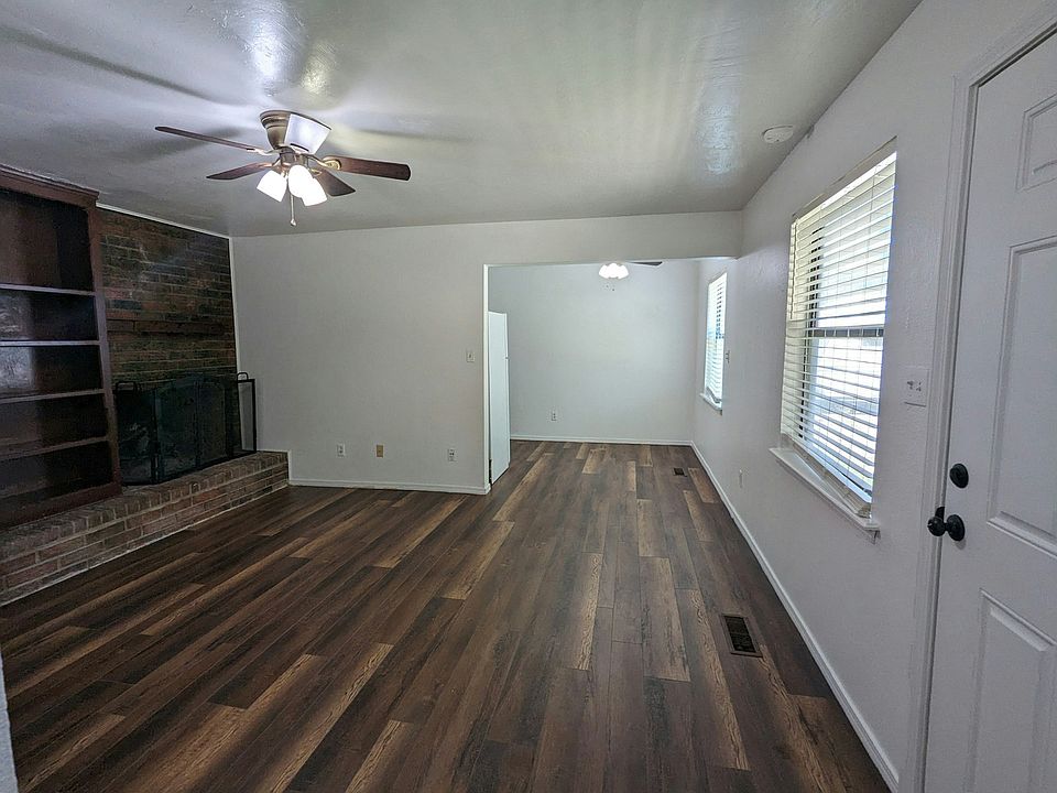 Living room with tall ceilings, fan/light fixture