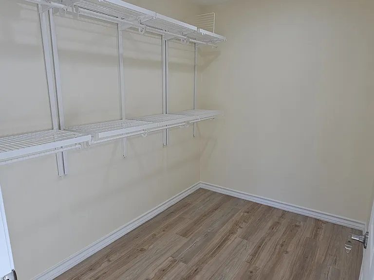 Master bedroom oversized walk-in closet with shelving