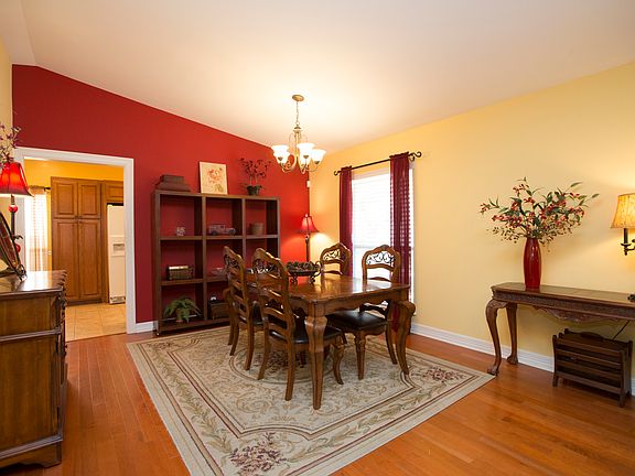 Generous Formal Dining Room with new flooring and designer paint accent wall. 