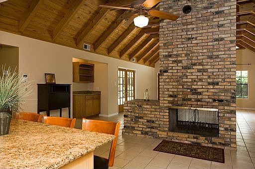 Double sided fireplace faces both Kitchen and Den.
