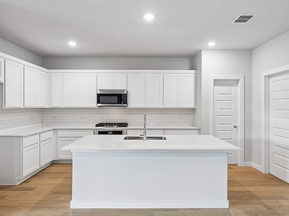 Kitchen in the Oscar home plan by Trophy Signature Homes - REPRESENTATIVE PHOTO