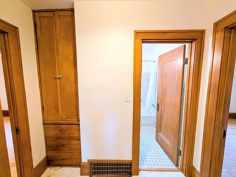 [UPPER UNIT]: Hall with linen closet, bathroom, and bedrooms to the left and right