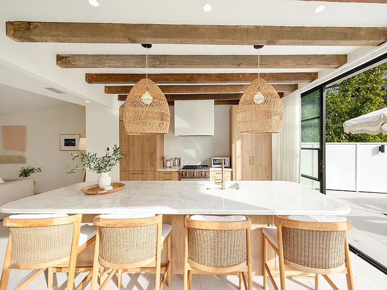 Floor-to-ceiling doors seamlessly blend indoor and outdoor living.