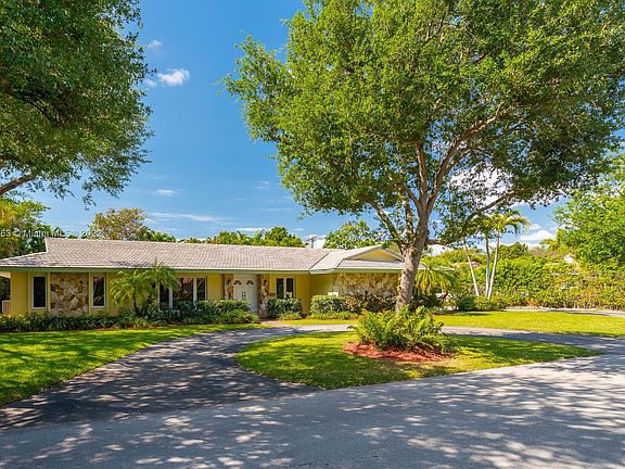 See how the circular driveway is about 1 foot higher than the Street? And the parking is ample! The 2 car garage is on the right hand side of house and as you will in the next picture has it's own driveway and a double gate for that new boat or RV!