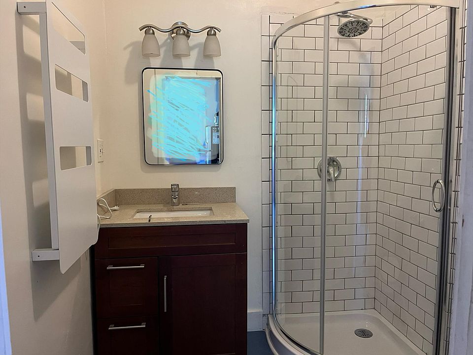 Bathroom includes a towel warmer, tiled shower, and new water-saving toilet.