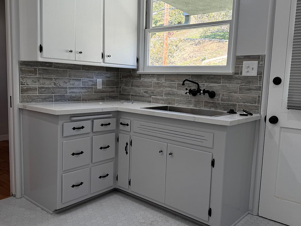 Updated 1940's kitchen with custom backsplash and floor tile
