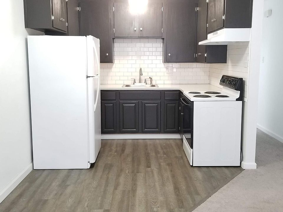 Subway tile backsplash, quartz countertops, and vinyl plank flooring.