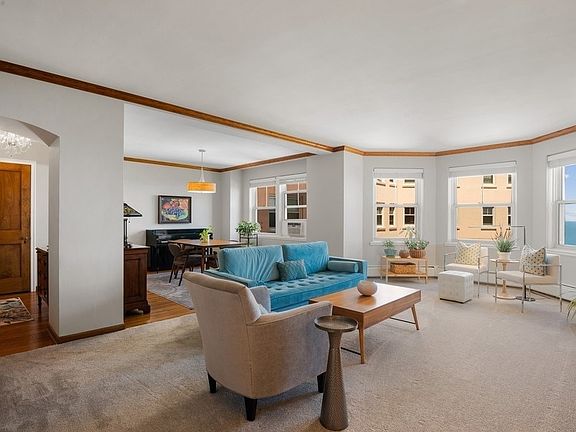 From this angle, you see the foyer to the left, the living room in the foreground and the dining roo