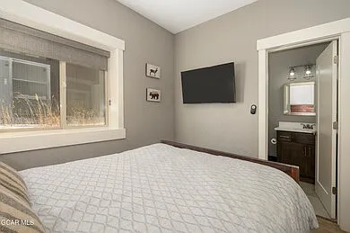 Bedroom and entry into bathroom