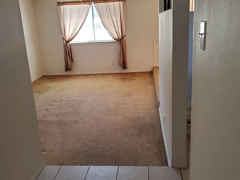 view of living room and drapes from entry