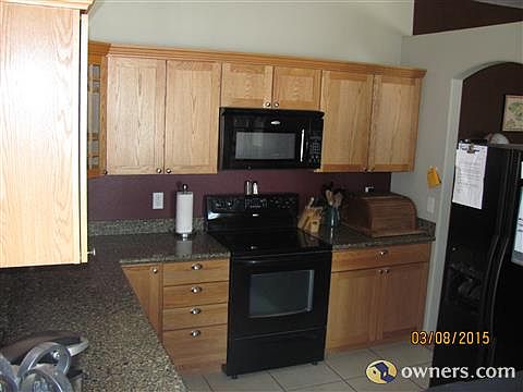 Kitchen w/ granite counter tops and tile flooring