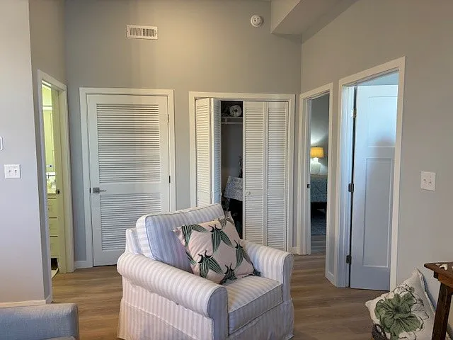 View from the living room with the bathroom to the Left, storage closet on back wall and entrances to both bedrooms on the right