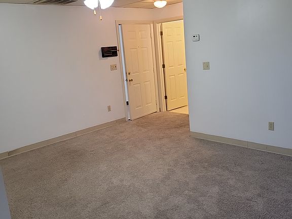 View of entry door from the kitchen, through the LR
