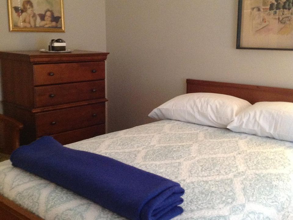 Upstairs bedroom which shares a Jack and Jill bathroom. French bed and art work.