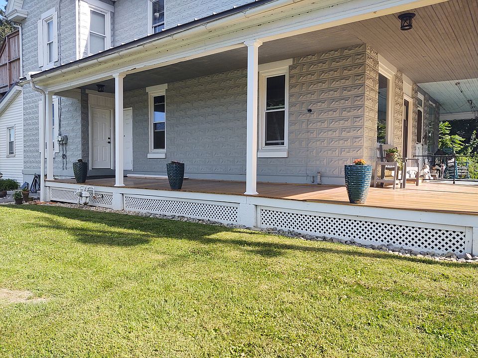 Wrap around mahogany porch, main entrance is black door in front, white door in bedroom / laundry and third door is your private storage locker