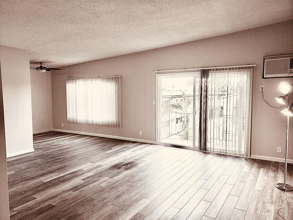 Huge Living Room with View Balcony & High Vaulted Ceiling, large windows & wood floors.