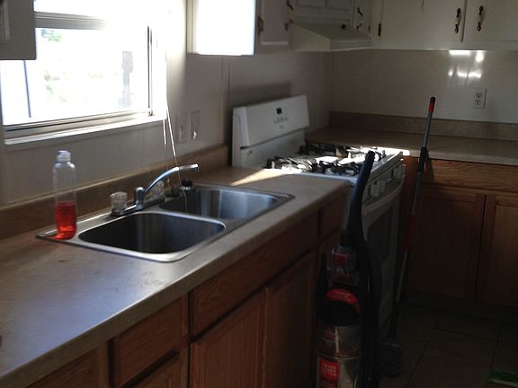 Large kitchen with full size cabinets and sink.