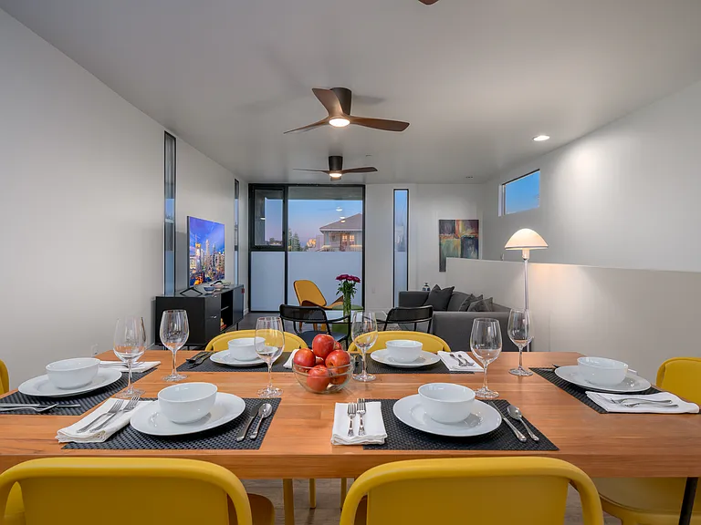 Great room with ceiling fans and large windows
