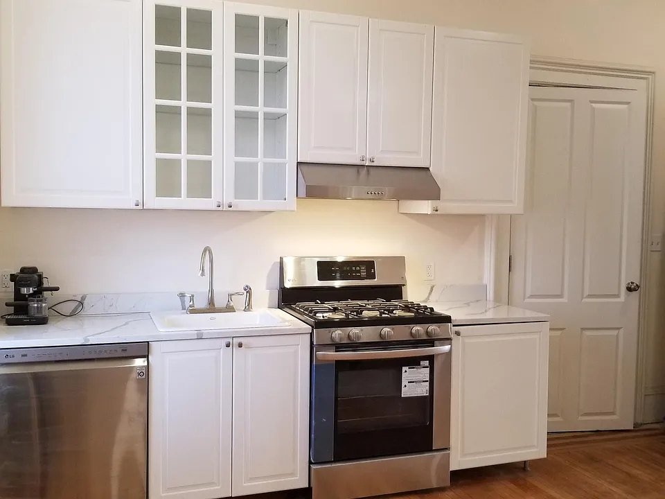 The cook's kitchen has new, energy-efficient, stainless steel appliances including a dishwasher, white quartz countertops and spacious, new cabinetry. Walk out the kitchen to the private 5'x20' deck for morning coffee or walk down into the 20'x75' landsc