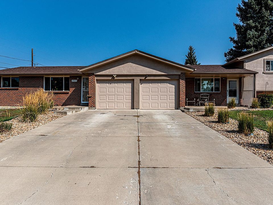 Front of house. #10423 is the right side unit with the attached garage on the right side.