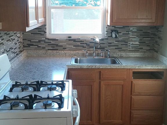 Kitchen with new glass tile backsplash, sink and counter top