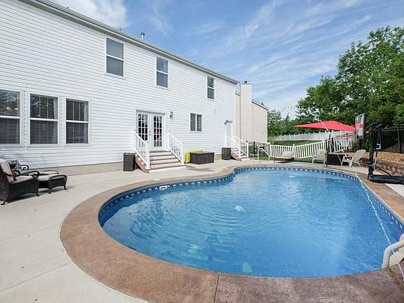 Back yard salt water pool with fountains, lights controlled by a phone app, layout shelf in pool, vacuum robot, pool cover, umbrella holder in concrete, did I mention its heated (swimming through October.  Luscious vegetation for privacy, back gate opens 