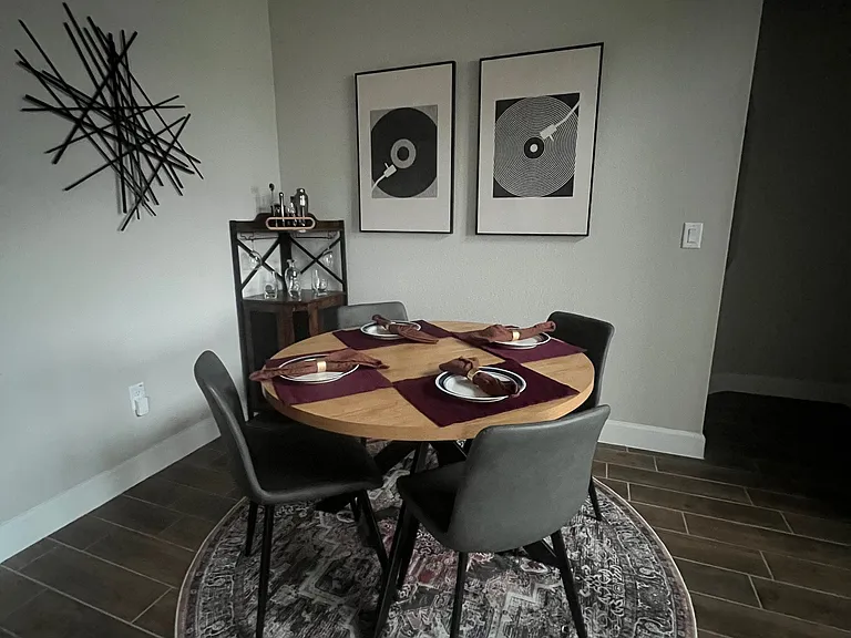 Stylish dining area featuring modern decor, a cozy round table, and elegant finishes_perfect for intimate meals or entertaining guests in a warm, inviting space.
