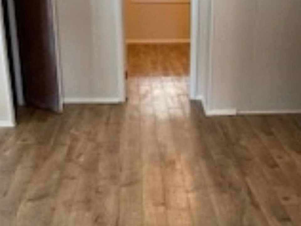 Living room with door going into bedroom. The little open door on the left is a storage space.