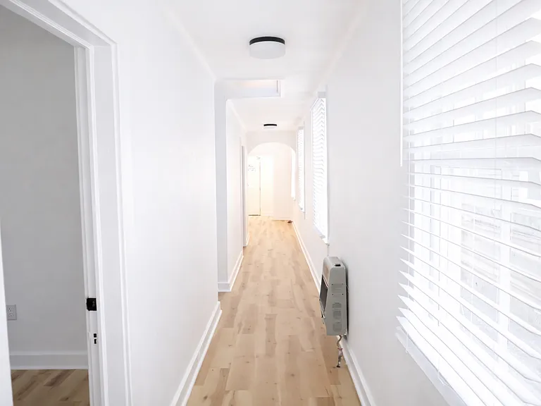 Light-filled hallway with wood-style flooring and a seamless flow throughout the home