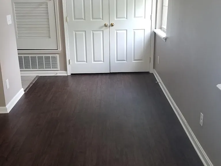 Living room with new Luxury Vinyl Floor, washer/dryer behind the door