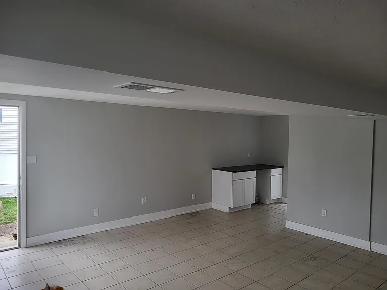 Lower level living area access from side yard and separate access to rear yard.
