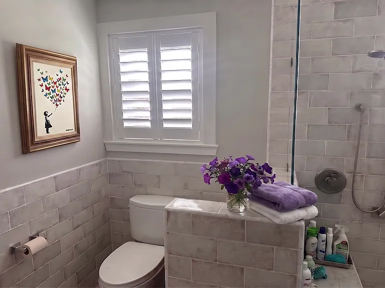 Adjacent toilet with wall plug for addition of bidet seat