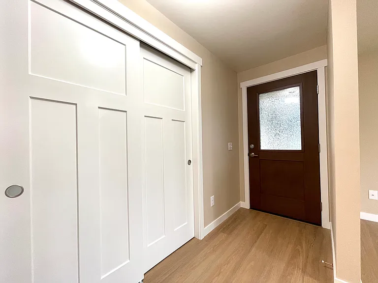 Entry with cool glass in the front door and big coat closet.