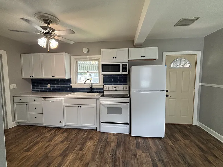 The kitchen appliances wall (the door leads to the backyard and garage)