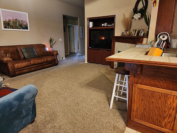 Living room TV and storage, fireplace in the corner.